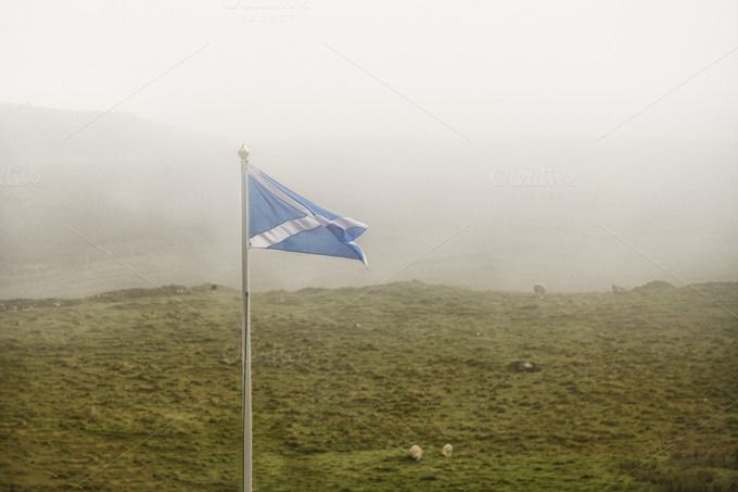 Scottish flag flying in foggy landscape Scottish flag flying in foggy landscape