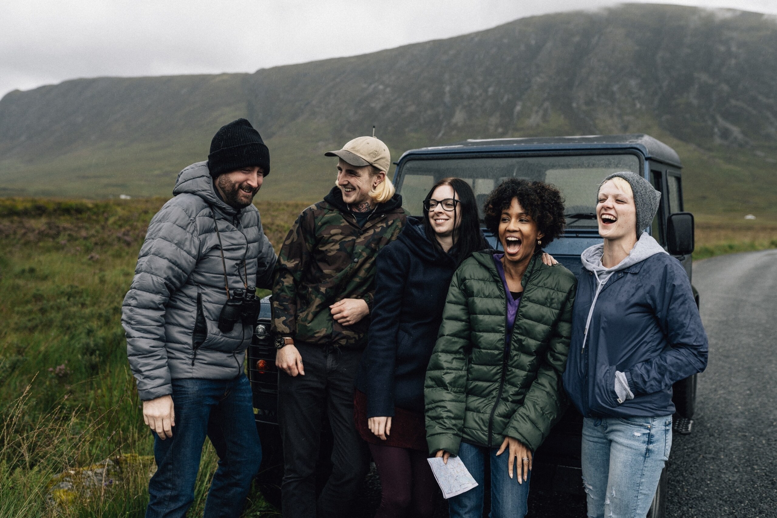 A group of friends taking a break from driving in Scotland, laughing and using Scottish slang A group of friends taking a break from driving in Scotland, laughing and using Scottish slang