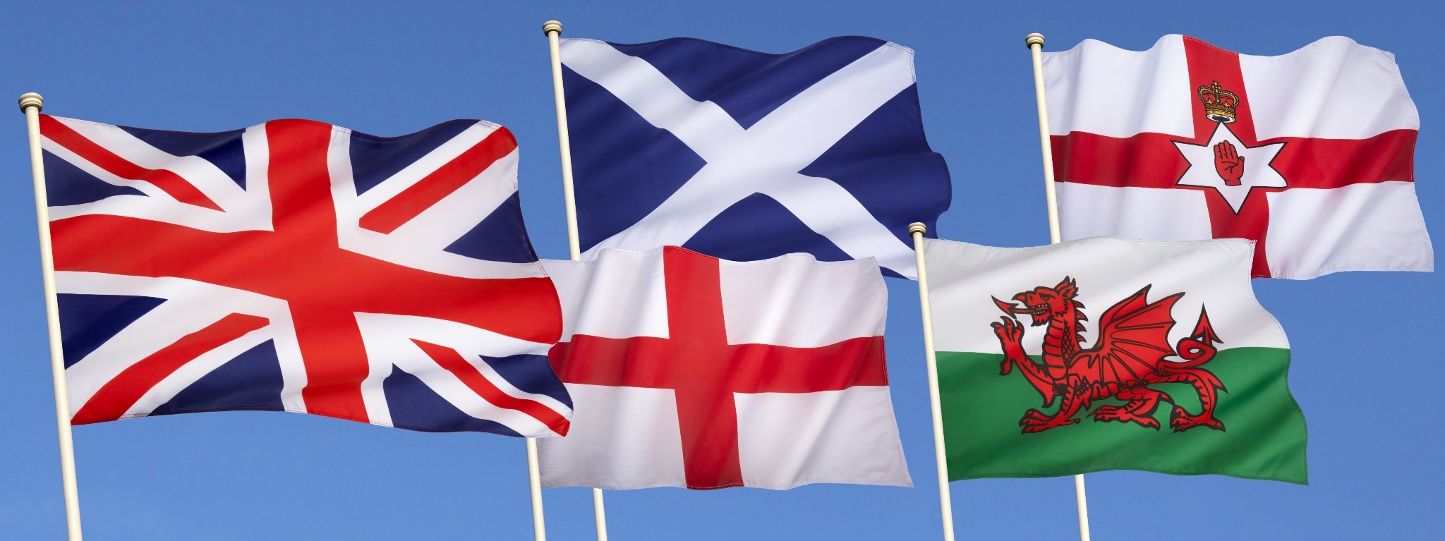 The flags of Great Britaina nd Ireland including the Welsh Drago, St. Andrew's Cross, Ulster Flag, the Union Jack and the flag of Northern Ireland. The flags of Great Britaina nd Ireland including the Welsh Drago, St. Andrew's Cross, Ulster Flag, the Union Jack and the flag of Northern Ireland.