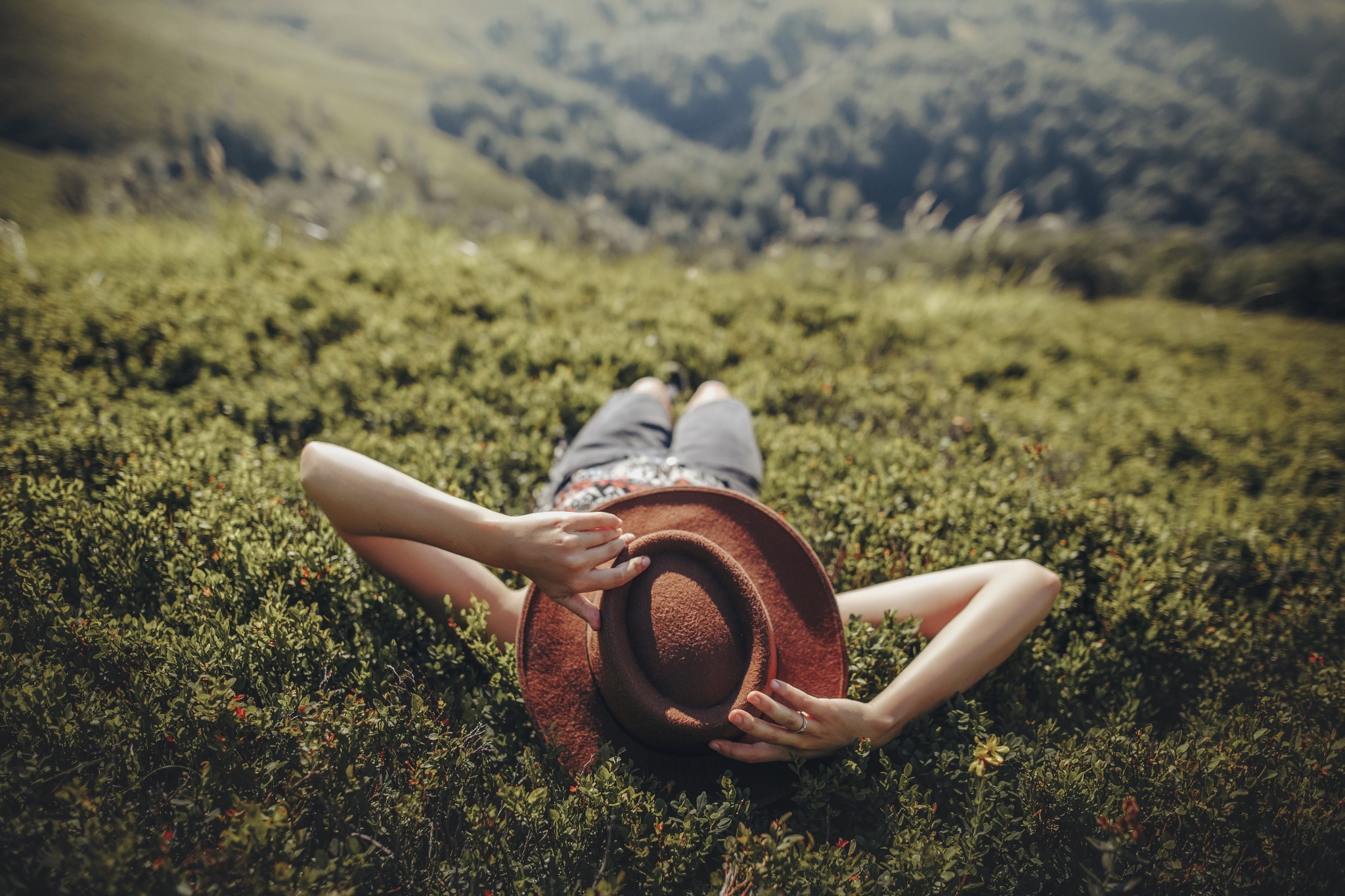 A woman alying in the grass and looking at the sky to reflect and celebrate Beltane. A woman alying in the grass and looking at the sky to reflect and celebrate Beltane.