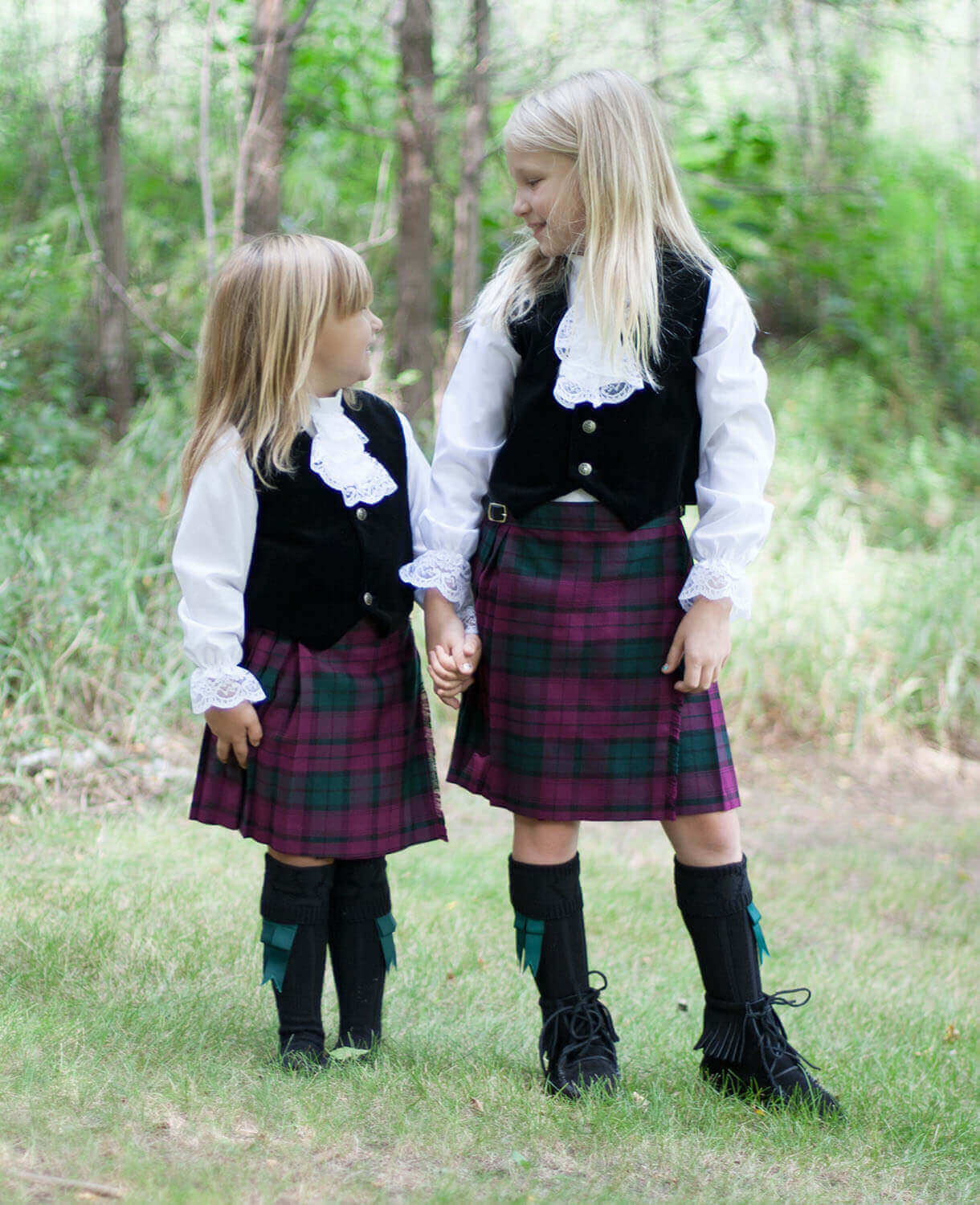two girls wearing kids kilts Two little girls wearing kilts they received as Christmas gifts