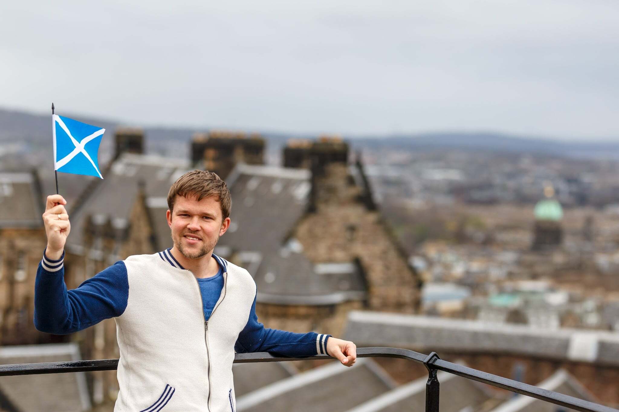 A man holding a Scottish flag A man holding a Scottish flag