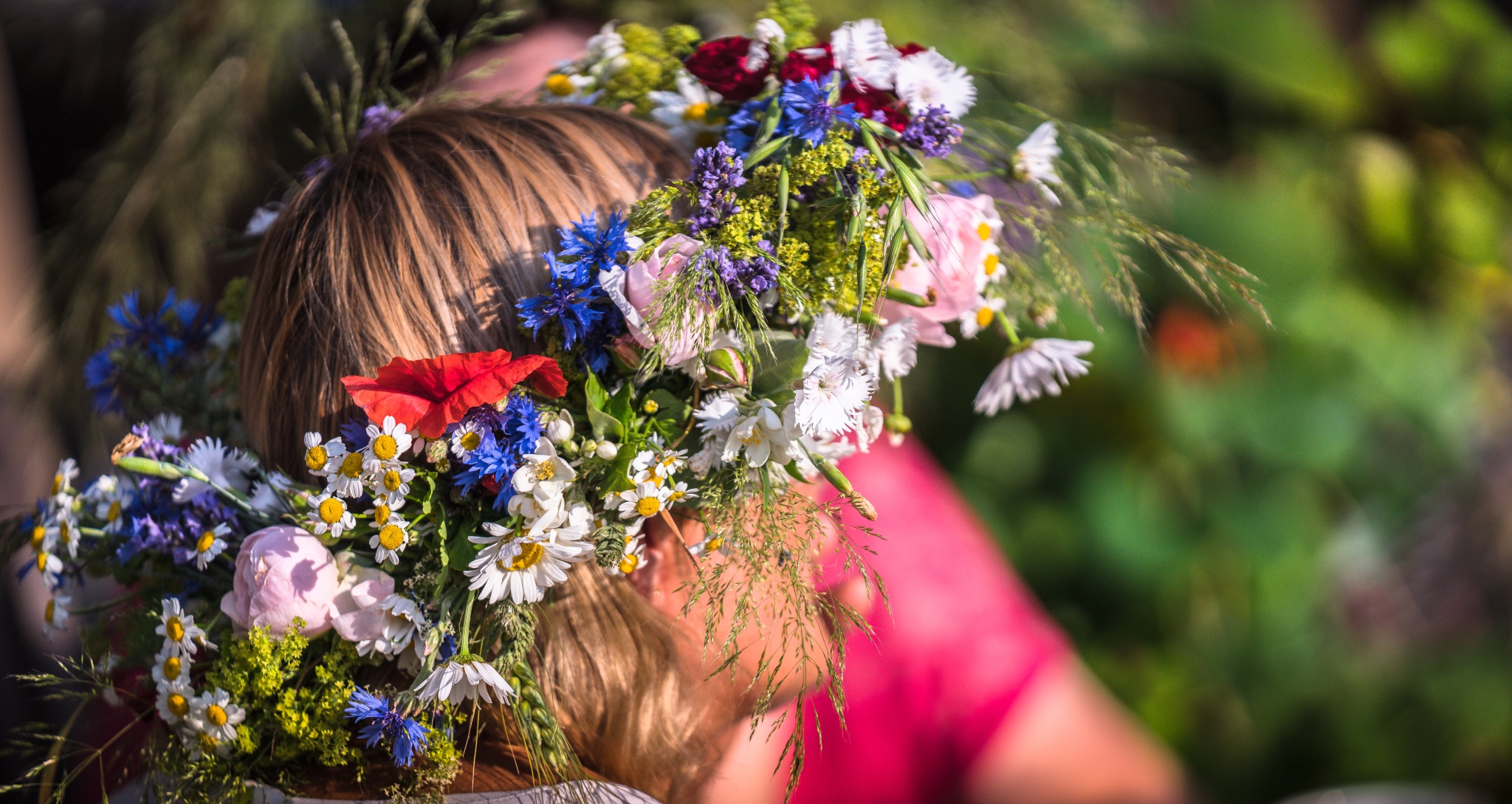 A summer solstice wreath on a woman's head