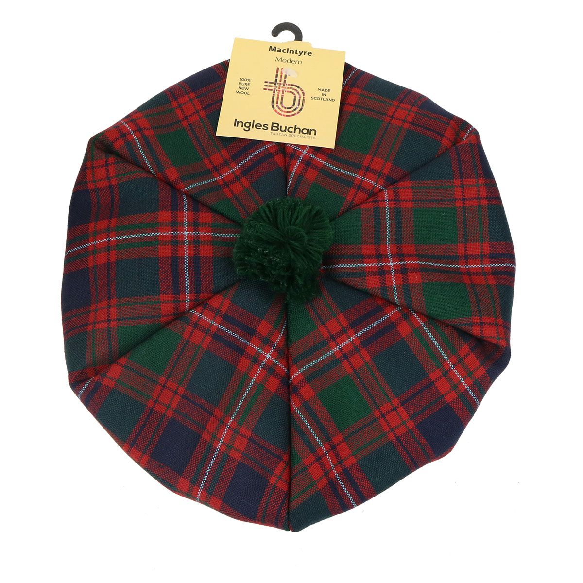 What is a tam? A top down view of a Macintyre tam o shanter. Red, navy, and green tartan with a green pom pom.