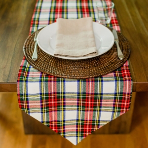 A traditional wedding setting with a tartan table runner.